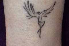 Tiny-bird-woman-tattoo